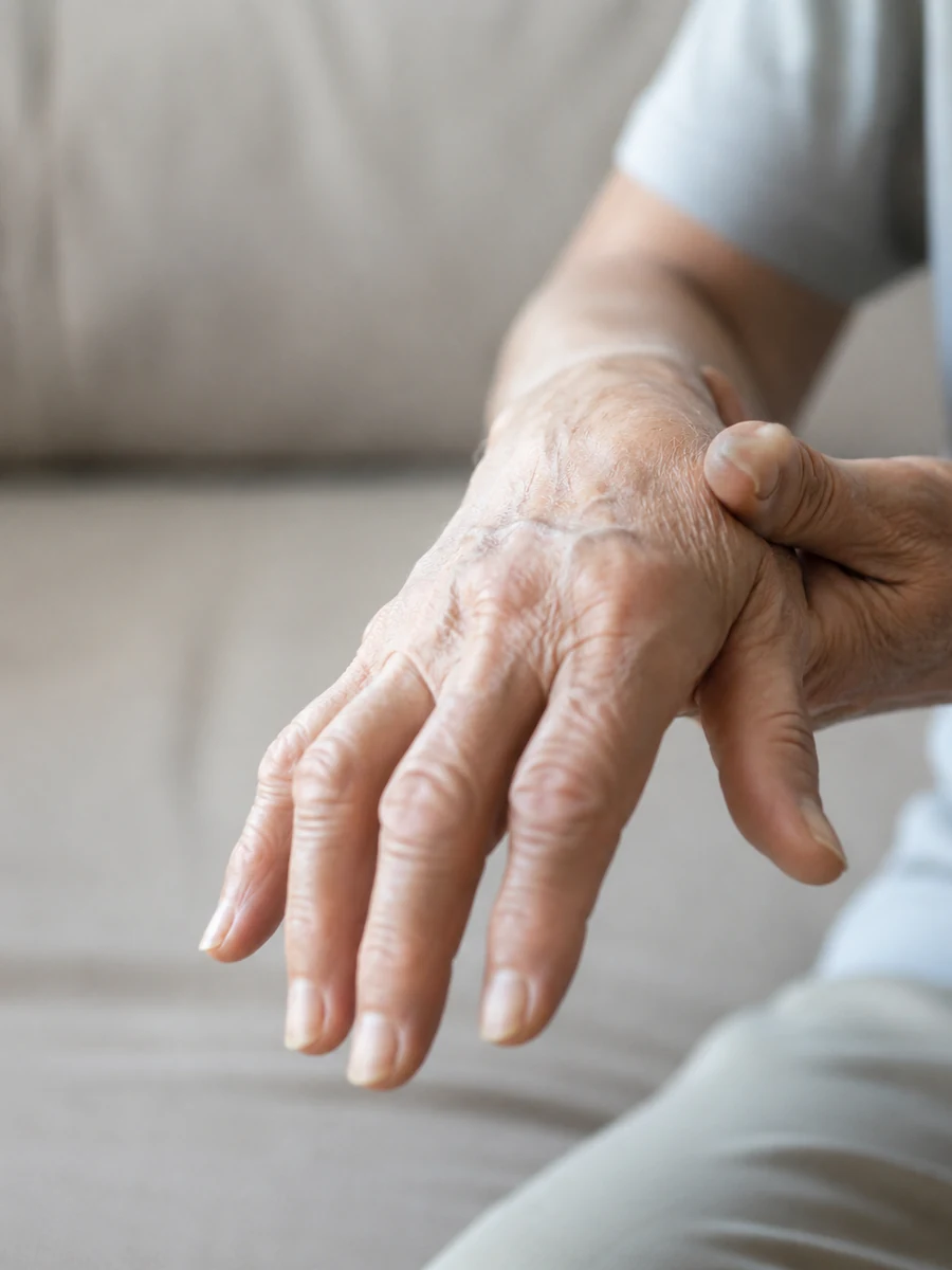 Older adult holding a painful arthritic hand